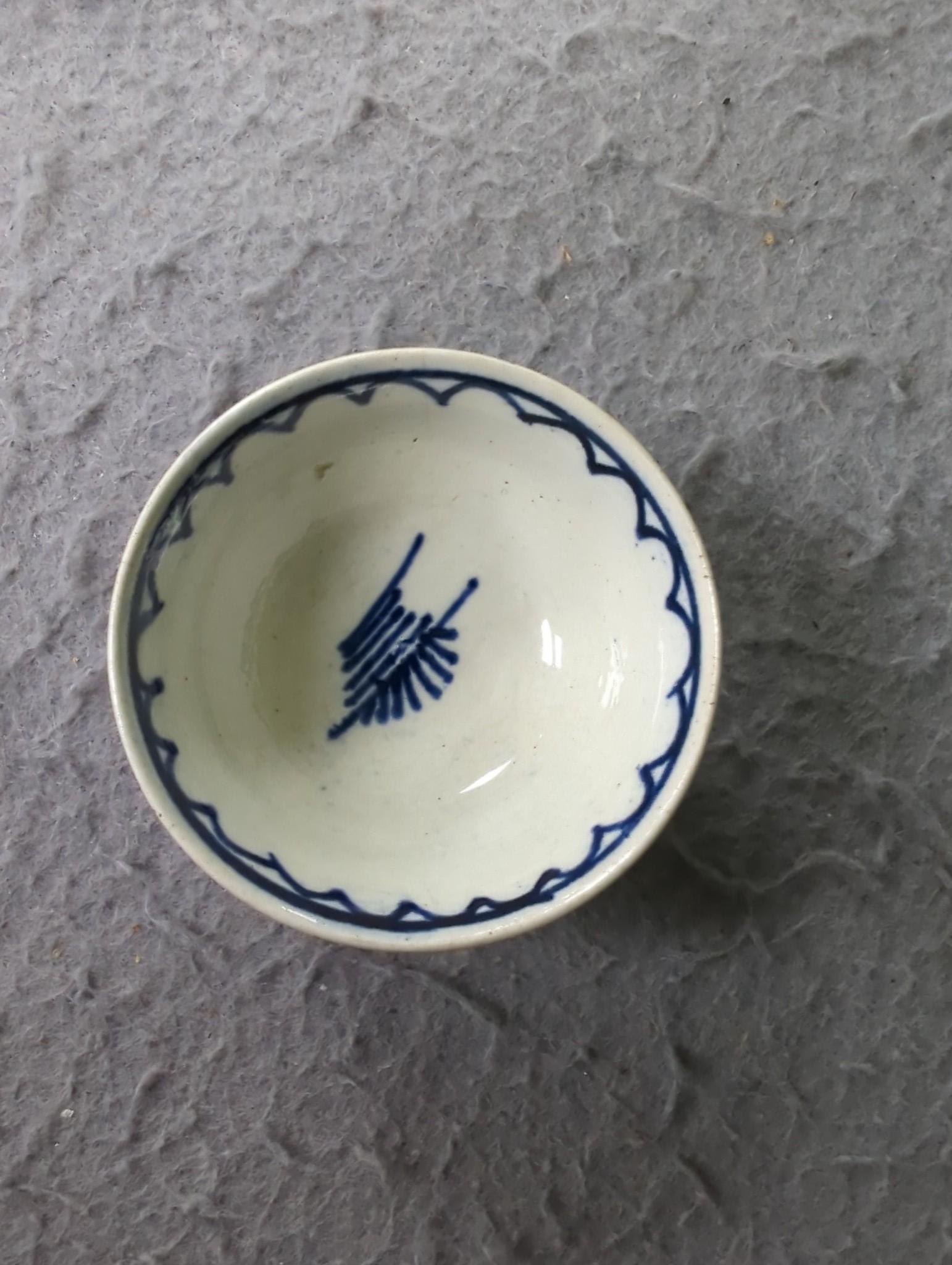 A late 18th century pearlware blue and white miniature jug, 5cm, and tea bowl and an English porcelain miniature mug, late 18th century